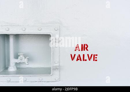 Industrial air valve on a white metal surface Stock Photo