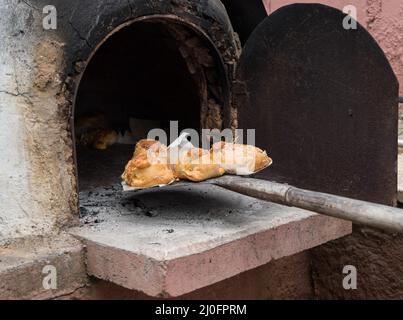 Cooked Cypriot Easter cheese pies Flaounes on a clay oven . Cyprus Stock Photo