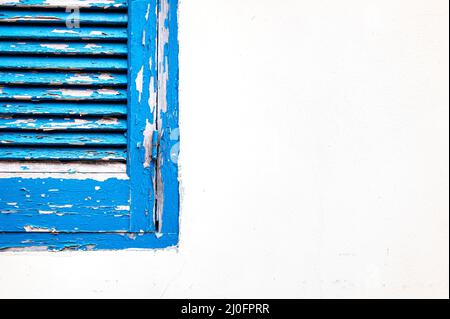Blue wooden closed window on a white wall Stock Photo