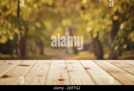 Autumn background image: wooden table in autumn Park. Stock Photo