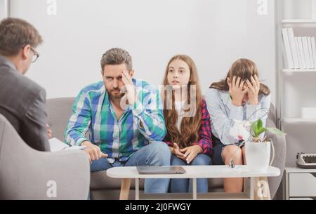 Family at psychology session. Psychological parents problem. Social worker psychologist talking to father mother and daughter teenage girl Stock Photo