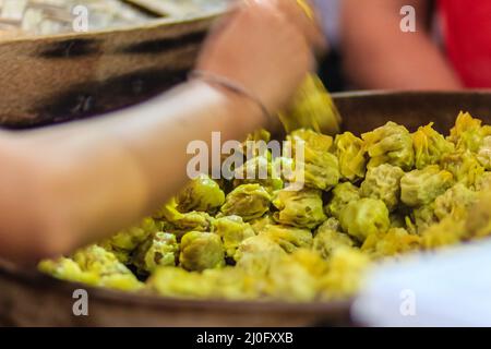 Close up street vendor during cooking and selling for Steamed shrimp pork shumai to customer at night market. Stock Photo