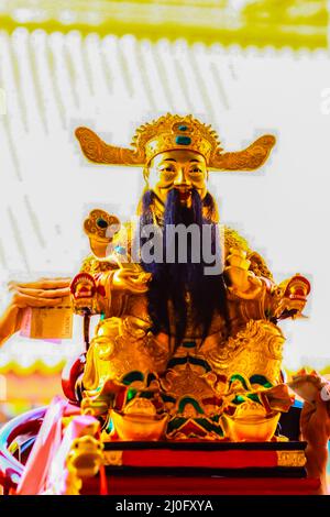 People take money bills touch with the Cai Shen, Chinese God of wealth, God of fortune image. They believed that this will be ma Stock Photo