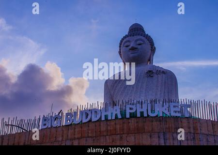 Amazing Massive white marble Buddha statue, the famous tourist attraction on top of hill in Phuket, Thailand. Stock Photo