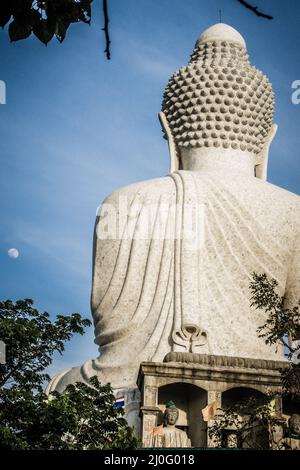 Amazing Massive white marble Buddha statue, the famous tourist attraction on top of hill in Phuket, Thailand. Stock Photo