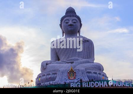 Amazing Massive white marble Buddha statue, the famous tourist attraction on top of hill in Phuket, Thailand. Stock Photo