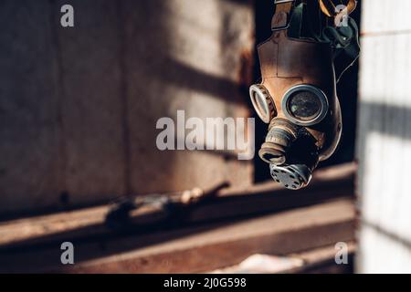 Old Soviet respirator for respiratory protection on the handicap of an old sunlit room. The concept of protection against corona Stock Photo