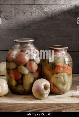 Canned vegetables in glass jars on a shelf in the basement Stock Photo