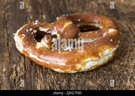 Bavarian butter pretzel on dark wood Stock Photo