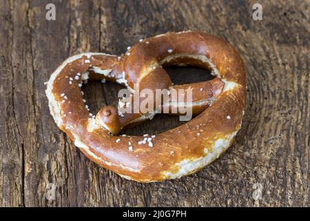 Bavarian butter pretzel on dark wood Stock Photo