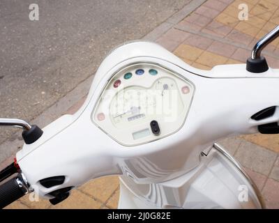 Speedometer on the handlebars of a white motorcycle. Closeup photo Stock Photo