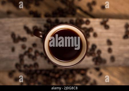Coffee and coffee beans on old rustic wood table Stock Photo