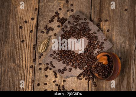 Coffee and coffee beans on old rustic wood table Stock Photo