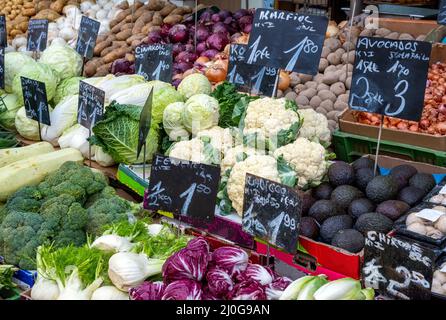 Big choice of fresh vegetables and salad for sale at a market Stock Photo