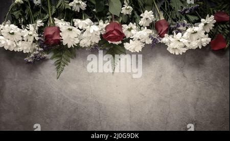White chrysanthemums and red roses on a dark background. Stock Photo