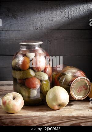 Canned vegetables in glass jars on a shelf in the basement Stock Photo