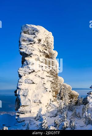 The rock is covered with snow in winter Stock Photo