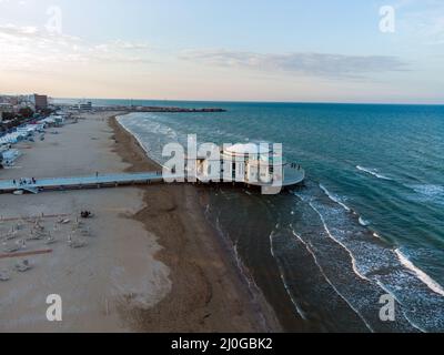 The roundabout on the sea at sunset in Senigalia Stock Photo