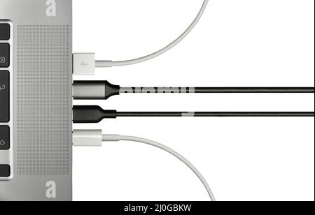 Various Computer Cables Plugged In To A Laptop Stock Photo