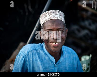 Senior man sitting on coast smiling, High quality photo Stock Photo