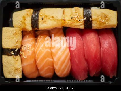 Nigiri sushi set in plastic container ready for takeout delivery. Closeup of take away lunch box Stock Photo