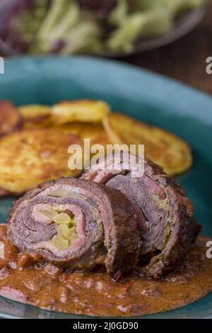 Close up of a meat roulade with potatoes Stock Photo