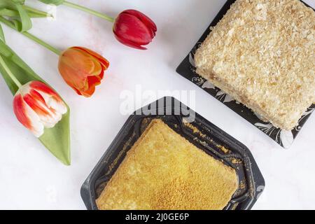 Delicious cake and flowers on the table Stock Photo