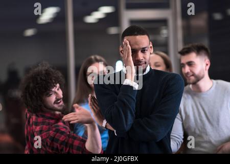 A group of young business people have fun playing interesting games while taking a break from work in a modern office. Selective focus  Stock Photo