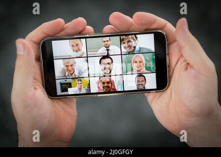 Online business conference smartphone in hands Stock Photo