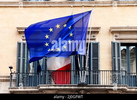 The flag of the European Community flying above the Italian flag on the balcony of a public building Stock Photo