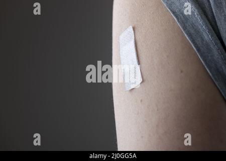 Patch on the arm after vaccination Stock Photo