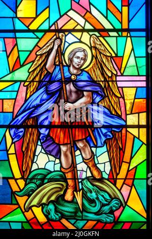 St. Michael the Archangel. Stained-glass window with Christian religious symbols seen in the Annunciation of the Blessed Virgin Mary Catholic Church Stock Photo