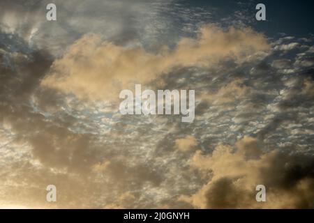 Beautiful orange colored clouds during sunset. Ceiling replacement tool. Stock Photo