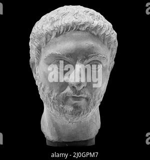 Gypsum copy of ancient statue man with beard head isolated on black background. Plaster sculpture man face Stock Photo