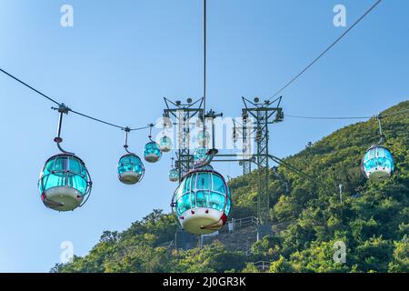 The sunny view of cable car and theme park near to ocean Stock Photo