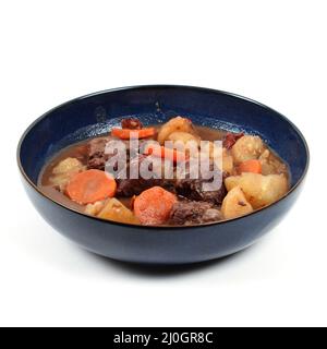Bourguignon beef in a deep plate on a white background Stock Photo