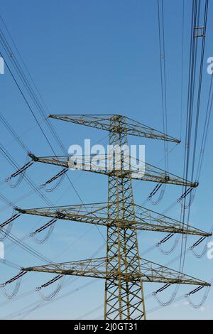 Overhead power line details. High voltage insulators and wires mounted ...