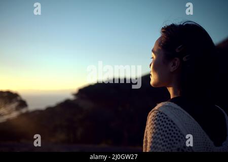 I needed this break. Shot of a woman admiring the scenery while spending time outdoors. Stock Photo