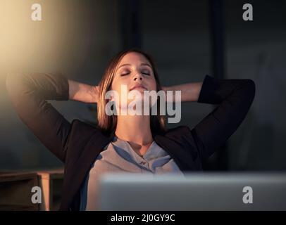 Just resting my eyes for a second. Shot of a young designer leaning back in her chair with her eyes closed. Stock Photo