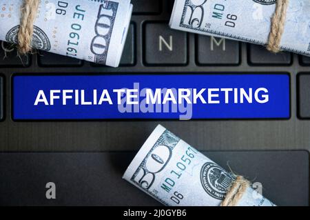 Affiliate marketing text on notepad with money background. Online business concept Stock Photo