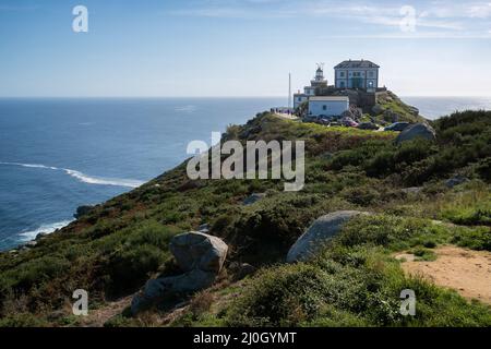 Cape finisterre landmark lighthouse with tourists on a sunny day in Galicia, Spain Stock Photo