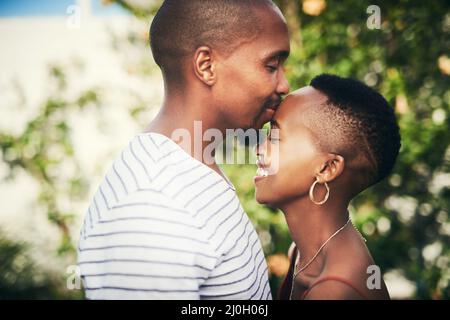 He makes me feel loved and cared for. Cropped shot of an affectionate couple standing outside. Stock Photo