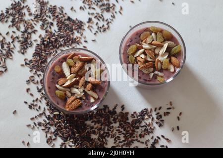 Black rice pudding. Made with black rice simmered in milk, sweetened with sugar and flavored with cardamom. Rice turns purple while cooking. It is the Stock Photo