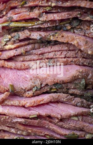 Stack of sliced pastrami meat Stock Photo