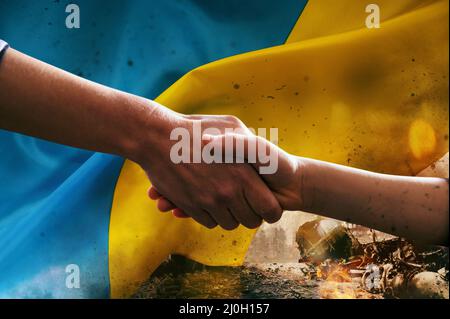 Sunny Ukraine country flag with helping hand as support Stock Photo