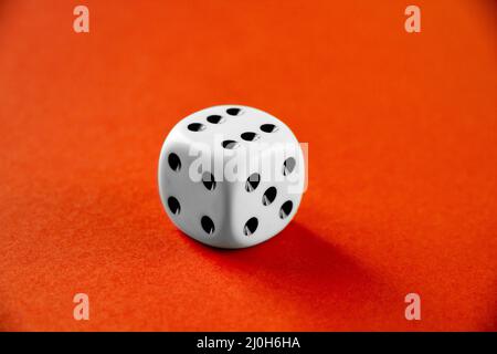 White dice isolated on orange background Stock Photo