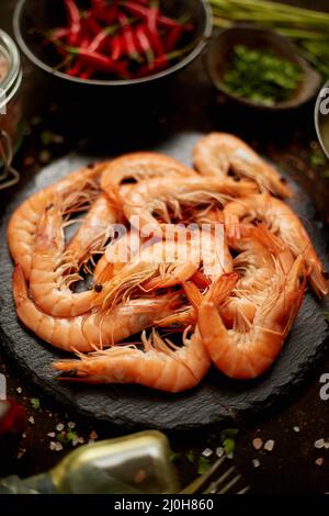 Fresh and raw big shrimps ready to be prepared. With various ingredients on side Stock Photo