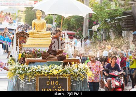 Samut Prakan, Thailand - MAY 12, 2012: Buddhist monk sprinkling the holy water during Songkran festival or traditional Thai New Year festival. Stock Photo