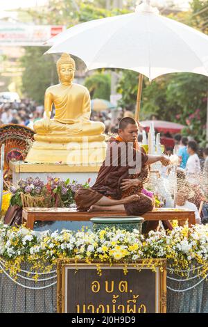 Samut Prakan, Thailand - MAY 12, 2012: Buddhist monk sprinkling the holy water during Songkran festival or traditional Thai New Year festival. Stock Photo
