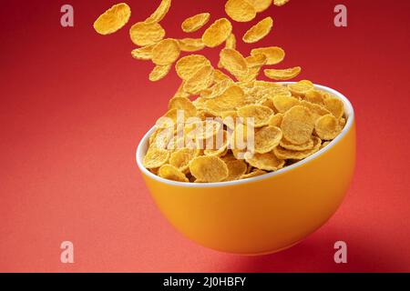 Bowl of corn flakes. Falling cornflakes with copy space Stock Photo